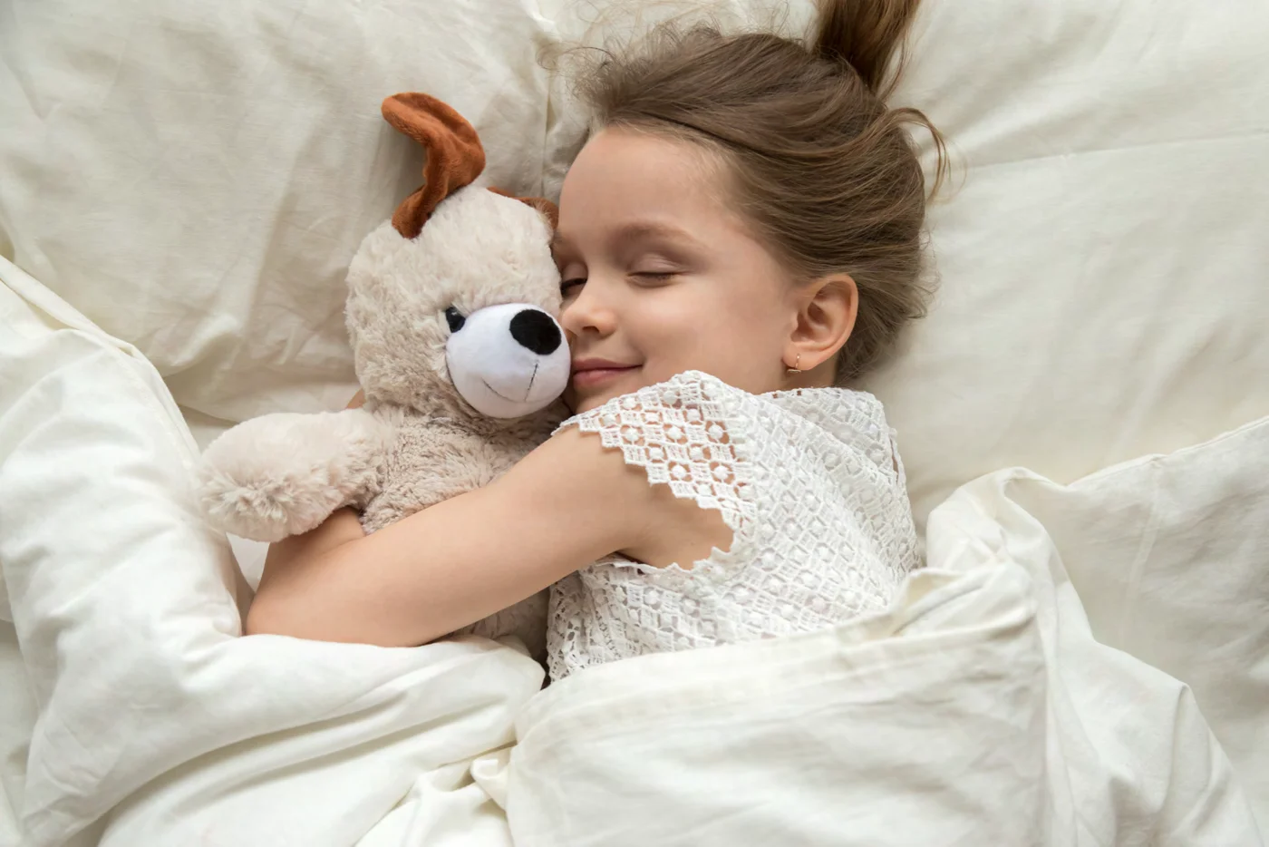 A child cuddling a favourite soft toy